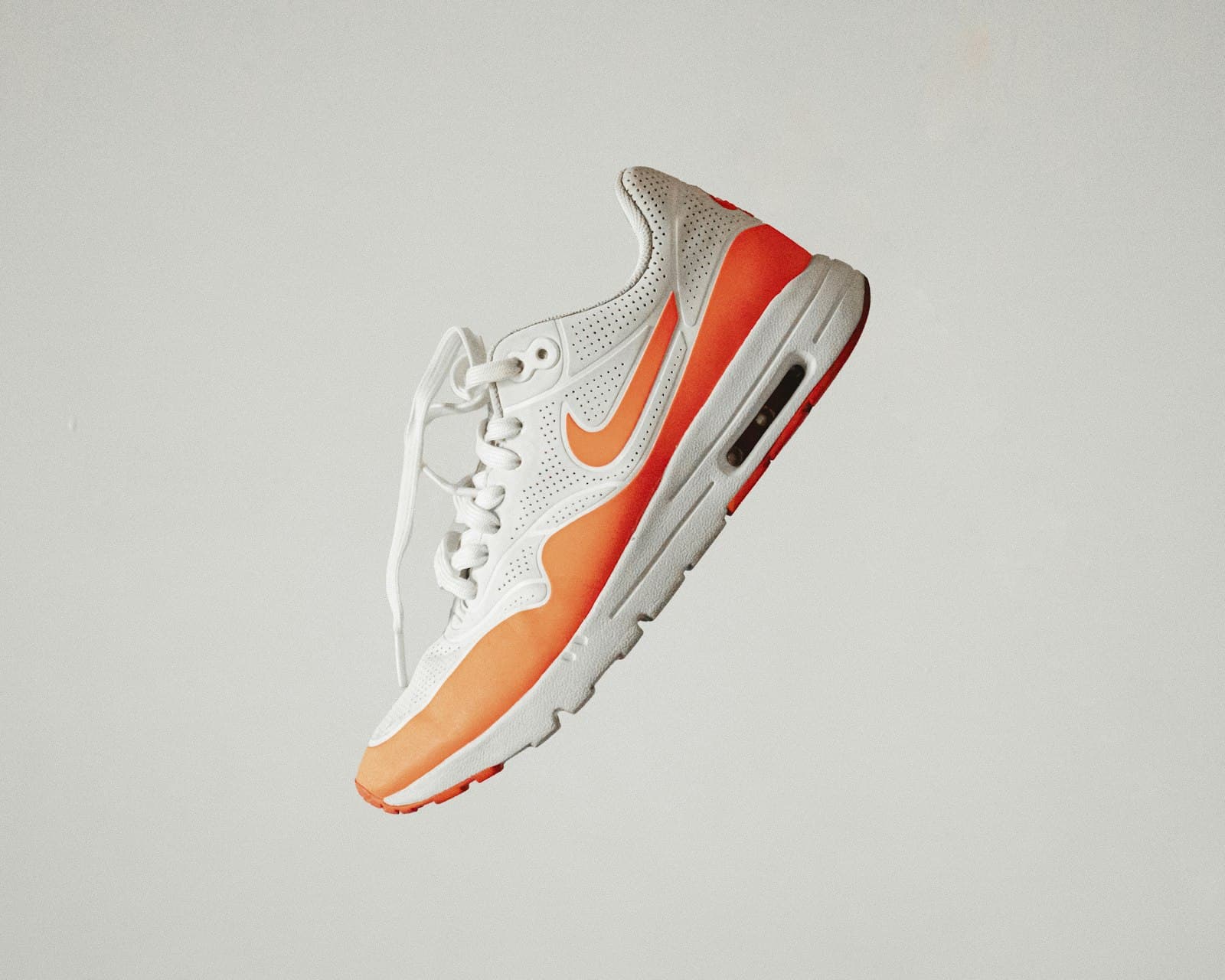 White sneaker with an orange sole